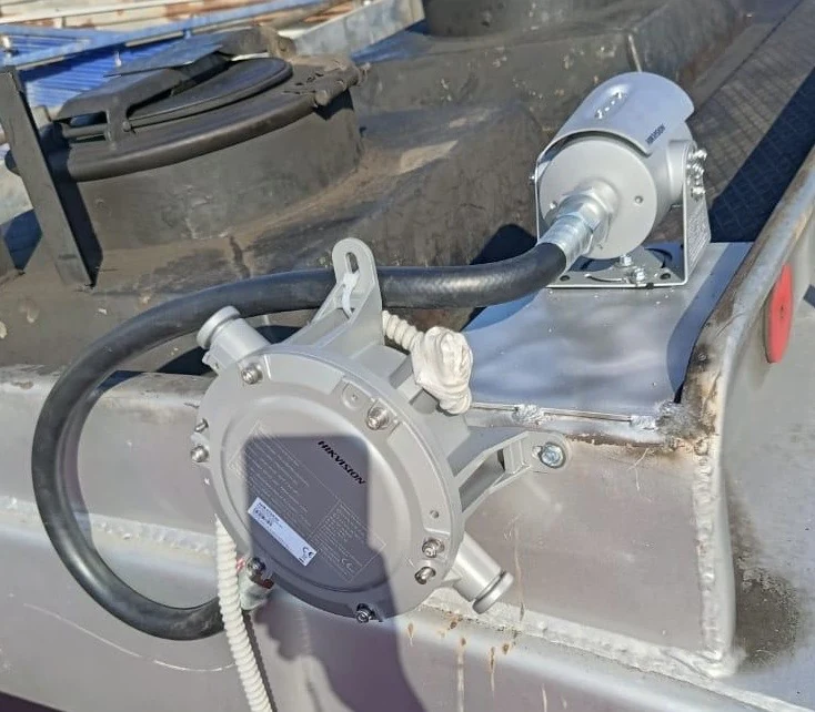 Explosion-proof camera on top of a fuel tanker, beside the hatch